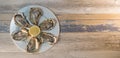 Fresh oysters white plate and lemon on wooden desk Royalty Free Stock Photo