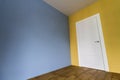 Fresh painted room interior with white door and wooden parquet f