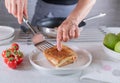 Woman serving a fresh and hot ham and cheese sandwich on a plate Royalty Free Stock Photo
