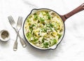 Fresh papardelle with chicken ragout , green peas and fennel in pan on wooden rustic board on light background, top view