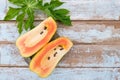 Fresh papaya fruit cut in half on wooden background Royalty Free Stock Photo