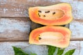 Fresh papaya fruit cut in half on wooden background Royalty Free Stock Photo