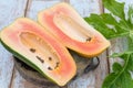 Fresh papaya fruit cut in half on wooden background Royalty Free Stock Photo