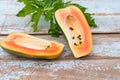 Fresh papaya fruit cut in half on wooden background Royalty Free Stock Photo