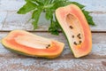 Fresh papaya fruit cut in half on wooden background Royalty Free Stock Photo