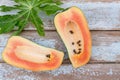 Fresh papaya fruit cut in half on wooden background Royalty Free Stock Photo