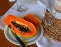 Fresh papaya on a white plate on a table. Healthy fruit.