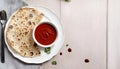 Fresh Paratha with Red Dipping Sauce on a Wooden Table, Copy Space