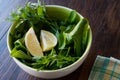 Fresh Parsley and Arugula / Rucola or Rocket Leaves with Lemon in Ceramic Bowl. Royalty Free Stock Photo
