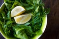 Fresh Parsley and Arugula / Rucola or Rocket Leaves with Lemon in Ceramic Bowl. Royalty Free Stock Photo