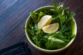 Fresh Parsley and Arugula / Rucola or Rocket Leaves with Lemon in Ceramic Bowl. Royalty Free Stock Photo