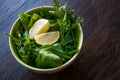 Fresh Parsley and Arugula / Rucola or Rocket Leaves with Lemon in Ceramic Bowl. Royalty Free Stock Photo