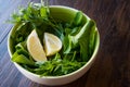 Fresh Parsley and Arugula / Rucola or Rocket Leaves with Lemon in Ceramic Bowl. Royalty Free Stock Photo