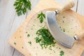 Fresh parsley on a board with mezzaluna