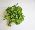 fresh parsley bunches seasoning natural organic on a white wooden background