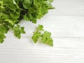 fresh parsley bunches on a white wooden background