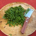 Fresh parsley leaves on a round wooden board