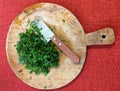 Fresh parsley leaves on a round wooden board Royalty Free Stock Photo