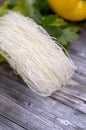 Fresh parsley, lettuce, noodels on a wooden gray table