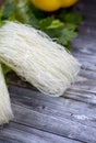 Fresh parsley, lettuce, noodels on a wooden gray table