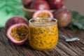 Fresh passion fruit in glass and organic passionfruit on wooden background