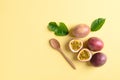 Fresh passion fruit with wooden spoon on yellow background Royalty Free Stock Photo