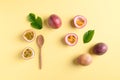 Fresh passion fruit with wooden spoon on yellow background Royalty Free Stock Photo