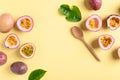 Passion fruit with wooden spoon on yellow background Royalty Free Stock Photo