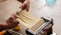 Fresh pasta maker machine. Dough homemade preparation. Hand make dough phylo close up view Royalty Free Stock Photo