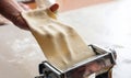 Fresh pasta maker machine. Dough homemade preparation. Hand make dough phylo close up view Royalty Free Stock Photo