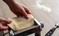 Fresh pasta maker machine. Dough homemade preparation. Hand make dough phylo close up view Royalty Free Stock Photo