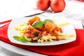 Fresh pasta with pork rind, tomato and basil Royalty Free Stock Photo