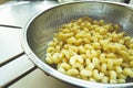 Fresh pasta in a stainless steel strainer