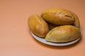 Fresh patties with meat, cabbage or any filling. Baked pies in the oven. On a white plate Royalty Free Stock Photo