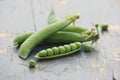 Fresh pea pods on a background of colored boards Royalty Free Stock Photo