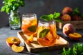 Fresh Peach iced tea. Iced tea with peach slices, mint and ice cubes on a wooden tray on dark background. Close up. Homemade Royalty Free Stock Photo