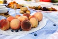 Fresh peach plate at outdoor picnic background Royalty Free Stock Photo