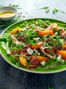 Fresh Peach salad with Parma ham, feta cheese and vegetables in a green plate. healthy food Royalty Free Stock Photo