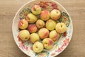 Peaches and colorful bowl. Fruits on wooden table. Overhead, fla