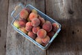 Fresh peaches fruits in basket on dark wooden rustic background, top view. Summer harvest of fruit. Still life. A group Royalty Free Stock Photo