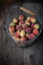 Fresh peaches fruits with in basket on dark wooden rustic background, top view. Summer harvest of fruits. Still life. A group of Royalty Free Stock Photo