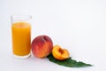 Glass of peach juice and fresh fruits isolated on white background Royalty Free Stock Photo