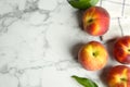 Fresh peaches, leaves and fabric on marble table. Space for text Royalty Free Stock Photo
