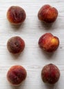 Fresh peaches on white wooden background, top view. Overhead, from above. Close-up Royalty Free Stock Photo
