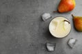 Fresh pear juice, ice cubes and fruits on grey table, flat lay. Space for text Royalty Free Stock Photo