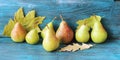 Fresh pears, autumn leaves on a wooden table, organic fruits