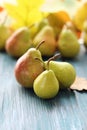 Fresh pears, autumn leaves on a wooden table, organic fruits Royalty Free Stock Photo