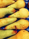 Fresh pears at the market,yellow pears on a blue background close up