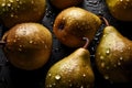 Fresh pears with water drops isolated on a dark background.