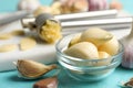 Fresh peeled garlic cloves in bowl on light blue wooden table, closeup. Organic product Royalty Free Stock Photo